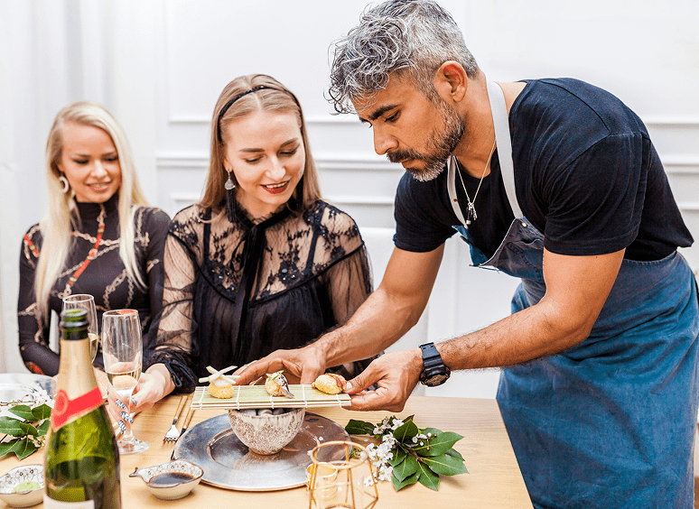 Server presenting dish to diners