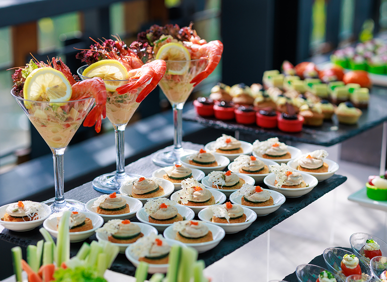 Elegant buffet with shrimp cocktails and canapés
