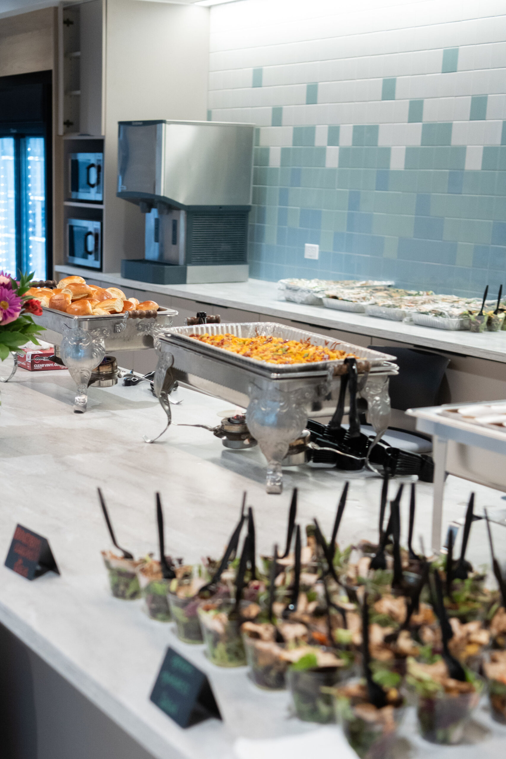 Elegant buffet setup with various appetizers and chafing dishes.