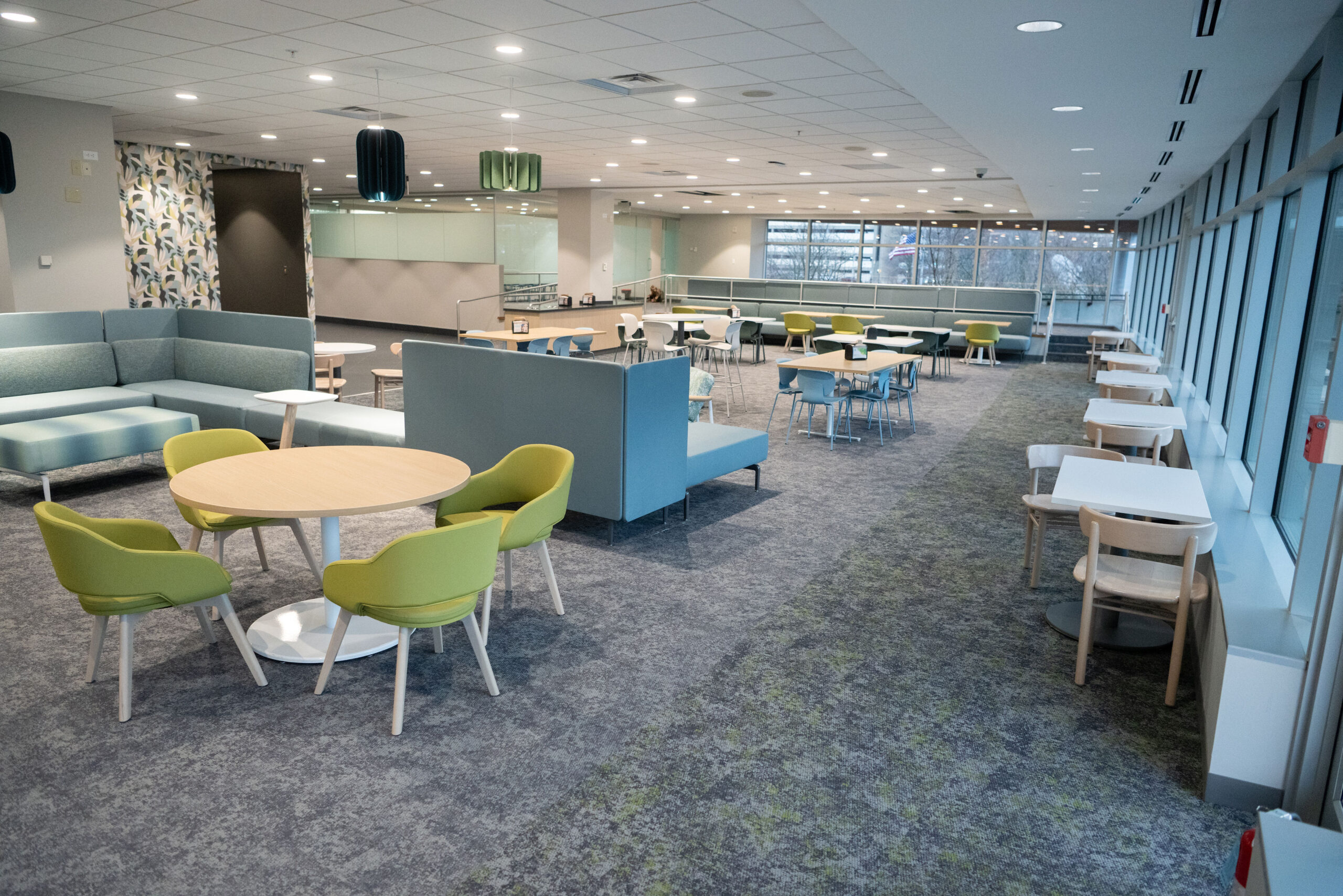 Modern cafeteria with colorful chairs and clean design.