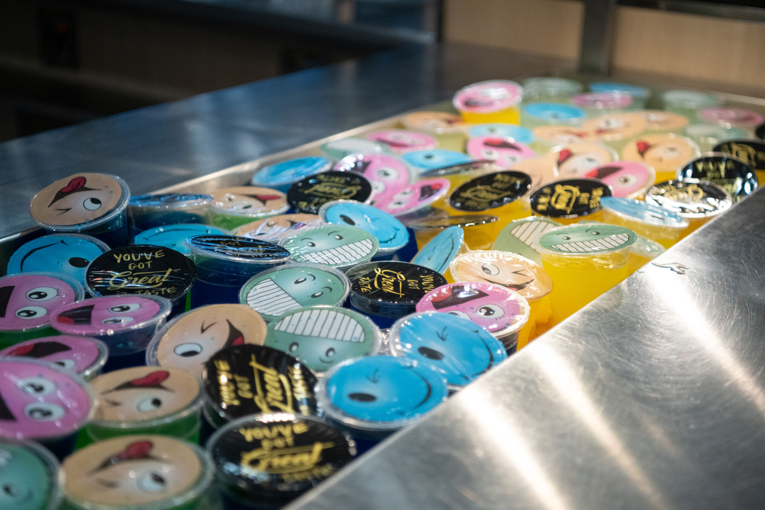 Colorful ice cream tubs displayed in a freezer.